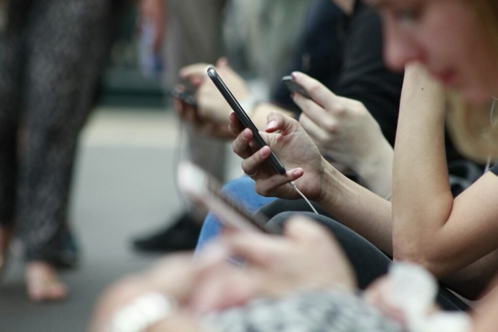 Personas consultan contenidos desde sus teléfonos móviles en un espacio público