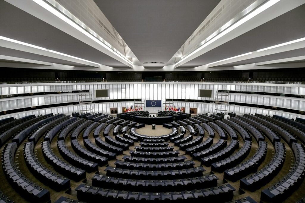 Vista superior de un recinto legislativo con curules distribuidas alrededor del salón